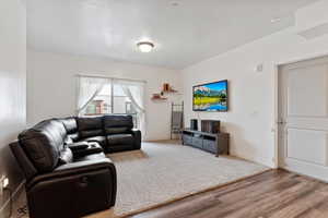 Living area with wood finished floors and baseboards