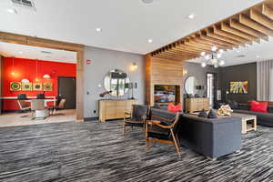 Living room with carpet and a chandelier