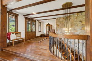 Foyer entrance featuring hardwood / wood-style floors and beamed ceiling