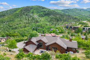 View from above of property featuring a heavily wooded area and mountains
