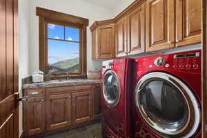 Washroom featuring cabinet space and washing machine and dryer