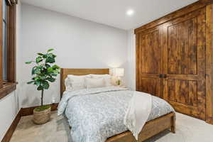 Carpeted bedroom featuring recessed lighting and baseboards