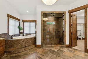 Full bath featuring a bath, a stall shower, and vanity