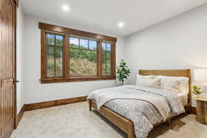 Carpeted bedroom with recessed lighting