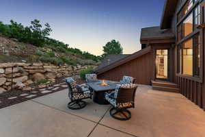 Patio terrace at dusk with a patio area and a fire pit