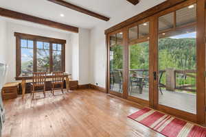Dining area with light wood-type flooring, beamed ceiling, french doors, and recessed lighting