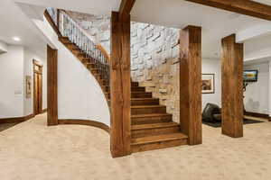 Stairs with carpet flooring and recessed lighting