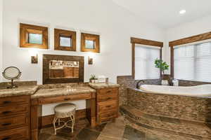 Bathroom with a bath, tile patterned floors, and recessed lighting