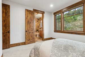 Bedroom featuring carpet, ensuite bath, and recessed lighting