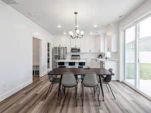 Kitchen featuring stainless steel appliances, a chandelier, plenty of natural light, light wood-type flooring, and recessed lighting