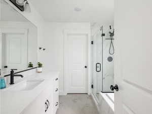Full bathroom with vanity, a marble finish shower, marble look tile flooring, and a bathtub