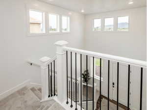 Stairway with recessed lighting and baseboards