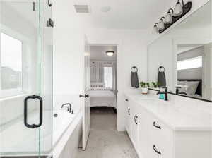 Bathroom with ensuite bathroom, vanity, a bath, a shower stall, and marble look tiles