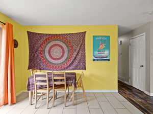 Dining room featuring light wood-type flooring and baseboards