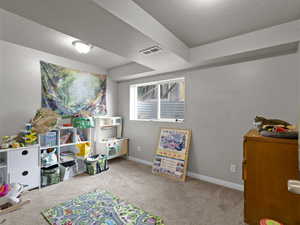 Game room with carpet flooring and a textured ceiling