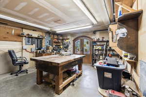 Garage with a workshop area and french doors