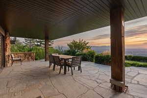 Patio terrace at dusk featuring a patio area and outdoor dining space