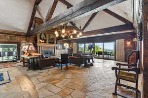 Lobby featuring high vaulted ceiling, a textured ceiling, and beam ceiling