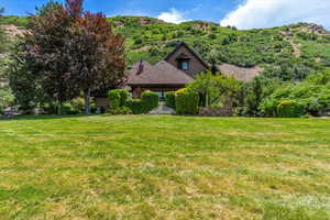 View of front facade with a front lawn and a chimney
