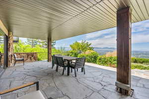 View of patio with outdoor dining space and a mountain view