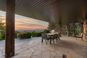Patio terrace at dusk with a patio, outdoor dining space, and grilling area