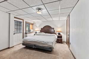 Bedroom with carpet flooring and a paneled ceiling
