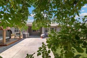 Ranch-style home featuring a patio, stucco siding, and a tiled roof