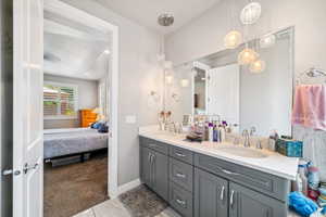 Full bathroom featuring double vanity and ensuite bath
