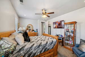 Carpeted bedroom with multiple windows, recessed lighting, and ceiling fan