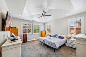 Bedroom with carpet floors, ceiling fan, recessed lighting, and a textured ceiling