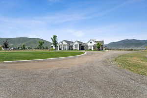 View of dirt / gravel road featuring a mountain view