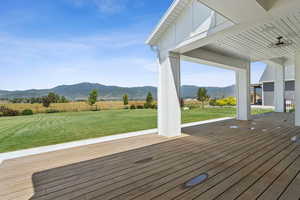 Wooden deck with a mountain view and a view of rural / pastoral area