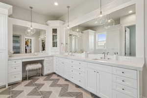 Bathroom featuring double vanity, recessed lighting, a walk in closet, and tile patterned floors