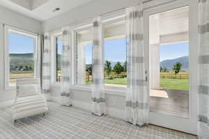 Sunroom / solarium with plenty of natural light and a mountain view