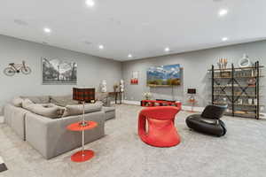 Carpeted living room with recessed lighting