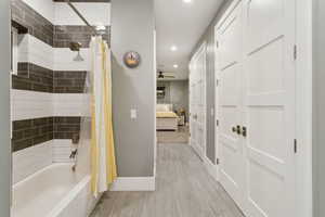 Full bathroom with shower / tub combo with curtain, recessed lighting, ensuite bathroom, wood finished floors, and a ceiling fan