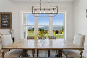 Dining space featuring healthy amount of natural light and a chandelier