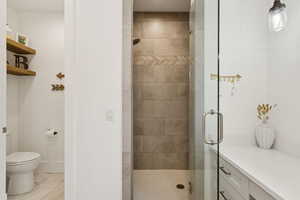 Bathroom featuring a shower stall and toilet