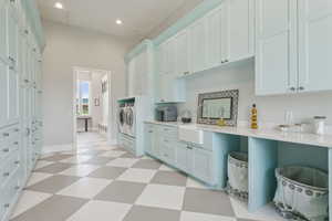 Kitchen featuring washer and clothes dryer, light floors, light countertops, and recessed lighting