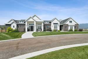 Modern inspired farmhouse featuring board and batten siding, french doors, a front lawn, and a standing seam roof