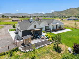 Back of house featuring a fenced backyard, a patio area, an outdoor hangout area, and a garage