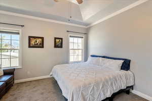 Primary Bedroom with crown molding, carpet floors, a textured ceiling, and ceiling fan