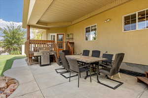 View of patio / terrace with a grill, outdoor dining space, and a deck