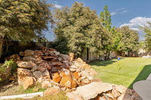 Fenced backyard with a putting green