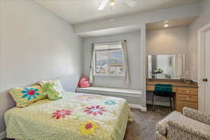 Bedroom 2 with built in vanity/desk, window seat, and walk in closet.