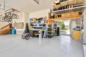 Garage featuring a garage door opener and back roll up door.