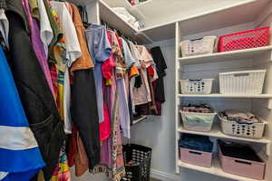 Bedroom 2 walk in closet featuring shelving