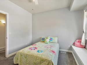 Bedroom 2 with built in vanity/desk, window seat, and ceiling fan.