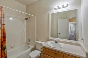 Bathroom featuring shower / tub combo with curtain and vanity