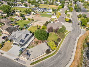 Aerial view of property and surrounding area featuring nearby suburban area